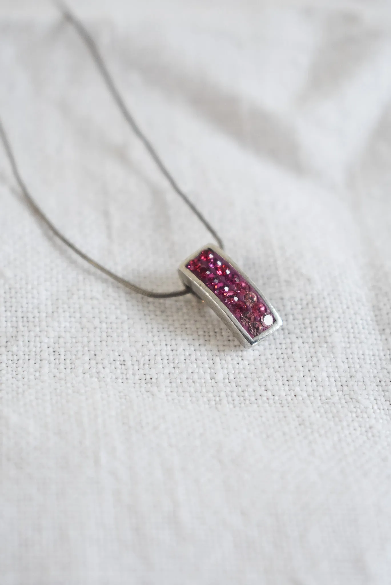 Pink sparkly pendant on silver chain